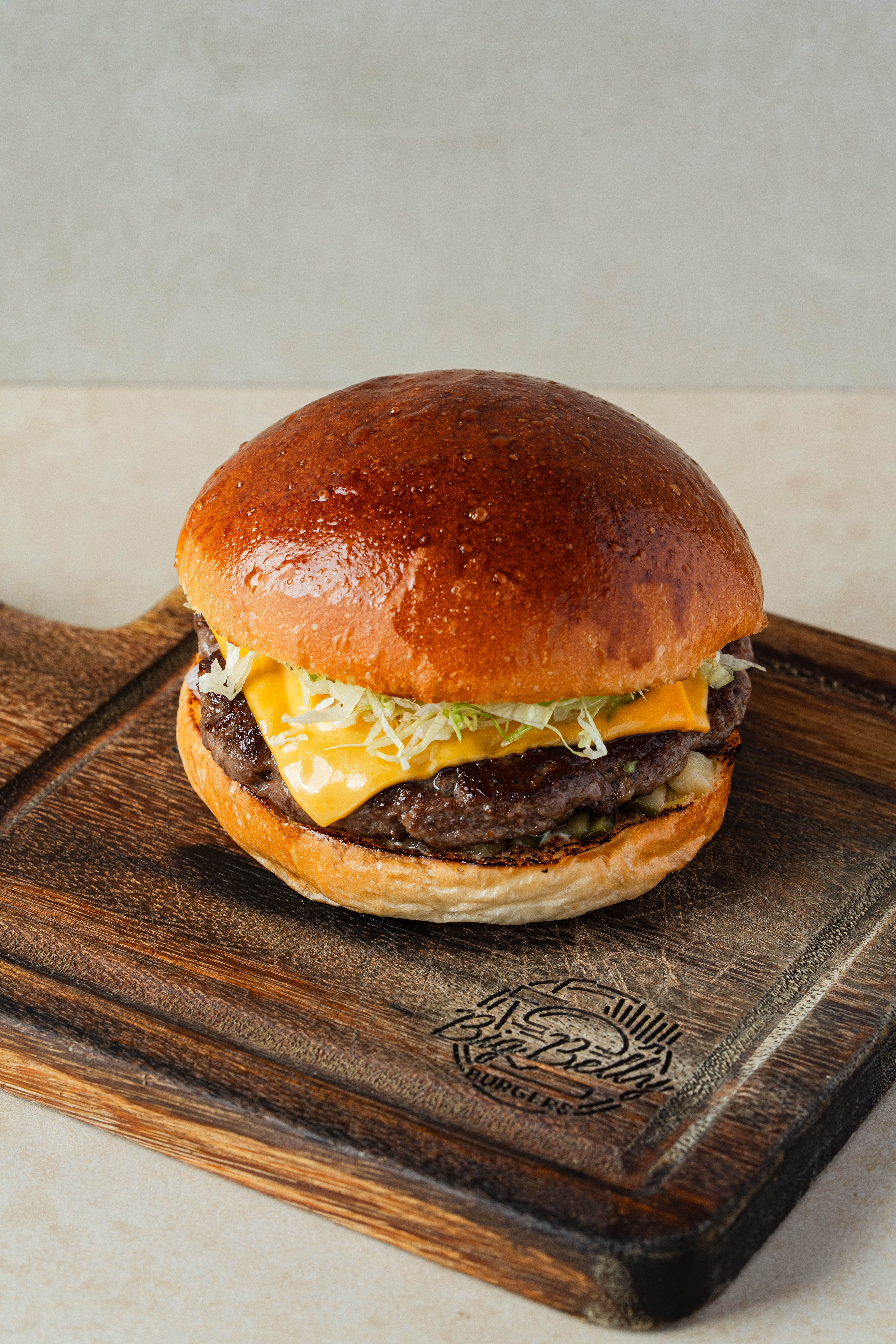 Big Belly burger on wooden board